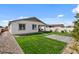Backyard features a well-kept lawn and mature landscaping at 730 W Wind Cave Dr, San Tan Valley, AZ 85140