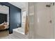 Bathroom with bathtub, shower, and blue accent wall, accessible from the main bedroom at 730 W Wind Cave Dr, San Tan Valley, AZ 85140