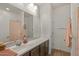 Bathroom features a long vanity with double sinks, a large mirror, and a shower with a pink patterned curtain at 730 W Wind Cave Dr, San Tan Valley, AZ 85140