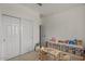 Bright bedroom with closet, tea party setup and shelving for toys at 730 W Wind Cave Dr, San Tan Valley, AZ 85140