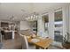 Bright dining area features modern light fixture and sliding glass doors to outdoor patio at 730 W Wind Cave Dr, San Tan Valley, AZ 85140