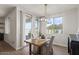 Inviting dining area with large windows, slider doors, and a modern light fixture above the table at 730 W Wind Cave Dr, San Tan Valley, AZ 85140