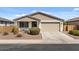 Charming single-story home with a well-maintained front yard and two-car garage at 730 W Wind Cave Dr, San Tan Valley, AZ 85140