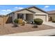 Well-maintained home featuring a two-car garage and manicured front yard landscaping at 730 W Wind Cave Dr, San Tan Valley, AZ 85140