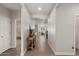 Open hallway with wood floors leading to various rooms, including a bedroom and the kitchen at 730 W Wind Cave Dr, San Tan Valley, AZ 85140