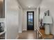 Bright hallway with wood floors, a black front door with windows, and stylish decor at 730 W Wind Cave Dr, San Tan Valley, AZ 85140