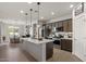 Modern kitchen featuring stainless steel appliances, a large island, and pendant lighting at 730 W Wind Cave Dr, San Tan Valley, AZ 85140