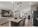 Open-concept kitchen with a central island, pendant lighting, and a view of the living room at 730 W Wind Cave Dr, San Tan Valley, AZ 85140