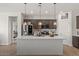 Bright kitchen with a large island, modern pendant lights, and stainless steel appliances at 730 W Wind Cave Dr, San Tan Valley, AZ 85140