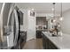 Modern kitchen featuring stainless steel appliances, dark cabinets, and a spacious layout at 730 W Wind Cave Dr, San Tan Valley, AZ 85140