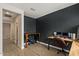 Office space with hardwood floors, a dark accent wall, and two desk setups at 730 W Wind Cave Dr, San Tan Valley, AZ 85140