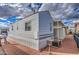 Manufactured home featuring exterior siding, brick paving, and a storage shed at 7750 E Broadway Rd # 294, Mesa, AZ 85208