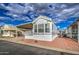 Manufactured home featuring covered parking, a porch and landscaped surroundings at 7750 E Broadway Rd # 294, Mesa, AZ 85208
