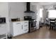 Kitchen with stainless steel range, custom cabinets, and dining area at 7807 E Main St # D-6, Mesa, AZ 85207