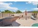 Backyard with built-in BBQ, pizza oven, table, chairs, and desert landscaping at 8004 W Robin Ln, Peoria, AZ 85383
