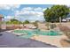 Backyard view with pool, spa, BBQ, pizza oven, desert landscaping, and string lights at 8004 W Robin Ln, Peoria, AZ 85383