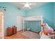 Bedroom features a bunk bed, desk, wood floors, and a window with shutter-style window treatment at 8004 W Robin Ln, Peoria, AZ 85383