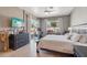 Serene bedroom features tile floor, mounted TV, and sliding glass door to patio at 8004 W Robin Ln, Peoria, AZ 85383
