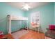 Bedroom with bunk bed, desk, neutral walls, and a window with shutter-style window treatment at 8004 W Robin Ln, Peoria, AZ 85383