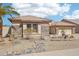 Attractive home with manicured desert landscaping, featuring rock accents, drought resistant plants and two-car garage at 8004 W Robin Ln, Peoria, AZ 85383