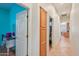 Hallway with white and wood-style doors, wood-style flooring, and an arched entryway at 8004 W Robin Ln, Peoria, AZ 85383