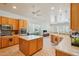 Bright kitchen with center island, stainless appliances, and an open layout leading into the living area at 8004 W Robin Ln, Peoria, AZ 85383