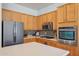 Close-up of a modern kitchen with stainless steel appliances, custom cabinetry, and stylish backsplash at 8004 W Robin Ln, Peoria, AZ 85383