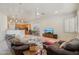 Spacious living room featuring leather furniture, an open floor plan, and a view of the kitchen at 8004 W Robin Ln, Peoria, AZ 85383