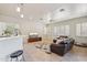 Inviting living room features tile floors, white shutters, and a stylish floral area rug at 8004 W Robin Ln, Peoria, AZ 85383