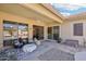 Covered patio with comfortable seating, ceiling fan, and access to the backyard at 8004 W Robin Ln, Peoria, AZ 85383
