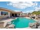 Backyard pool with spa, desert landscaping, BBQ, pizza oven, and desert landscaping at 8004 W Robin Ln, Peoria, AZ 85383