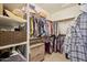 Organized walk-in closet with custom shelving and ample storage space for clothing at 8004 W Robin Ln, Peoria, AZ 85383