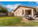 Backyard showcasing the home's exterior, a shed, and a cozy patio setup, perfect for outdoor enjoyment at 8325 N 61St Ln, Glendale, AZ 85302