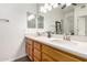 Bright bathroom featuring a dual sink vanity with quartz countertops, modern fixtures, and wood-look floors at 8325 N 61St Ln, Glendale, AZ 85302