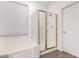 Bright bathroom features a shower with gold trim, a large window and a soaking tub at 8325 N 61St Ln, Glendale, AZ 85302