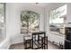 Charming breakfast nook illuminated by natural light from a large window and sleek table with stools at 8325 N 61St Ln, Glendale, AZ 85302