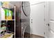 Efficient laundry area with stacked washer and dryer, shelving for supplies, and convenient access to the garage at 8325 N 61St Ln, Glendale, AZ 85302
