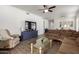 Open-concept living room with wood-look tile flooring and comfortable seating at 8325 N 61St Ln, Glendale, AZ 85302