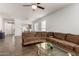 Inviting living room features a plush corduroy sectional and wood-look tile flooring throughout the open floor plan at 8325 N 61St Ln, Glendale, AZ 85302