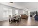 Bright, open living room and dining area with wood-look tile flooring and neutral colors at 8325 N 61St Ln, Glendale, AZ 85302