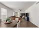 Bright, open living room and dining area with wood-look tile flooring and neutral colors at 8325 N 61St Ln, Glendale, AZ 85302