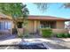 Charming condo with a red tile roof and a well-manicured front yard provides guest parking space at 8625 E Belleview Pl # 1012, Scottsdale, AZ 85257