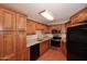 Traditional kitchen with granite countertops, stainless steel appliances, and wood cabinetry at 8625 E Belleview Pl # 1012, Scottsdale, AZ 85257