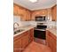 Kitchen with tile flooring, granite countertops, and stainless steel appliances at 8625 E Belleview Pl # 1012, Scottsdale, AZ 85257