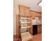 Kitchen pantry pull out shelving system in natural wood cabinets at 8625 E Belleview Pl # 1012, Scottsdale, AZ 85257