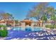 Sparkling community pool area featuring lounge chairs and covered seating for relaxation at 8625 E Belleview Pl # 1012, Scottsdale, AZ 85257