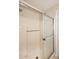 Bright shower with white tile and a sliding glass door enclosure at 8625 E Belleview Pl # 1012, Scottsdale, AZ 85257