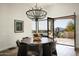 Modern dining area with chandelier, mountain views, and seamless flow to outdoor living space at 9188 E Bajada Rd, Scottsdale, AZ 85262