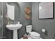 Cozy powder room featuring a pedestal sink, neutral wall color, and stylish decor at 9734 E Spiral Ave, Mesa, AZ 85212