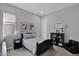 Neutral bedroom features a black bed, dark wood furniture, and decor at 9734 E Spiral Ave, Mesa, AZ 85212